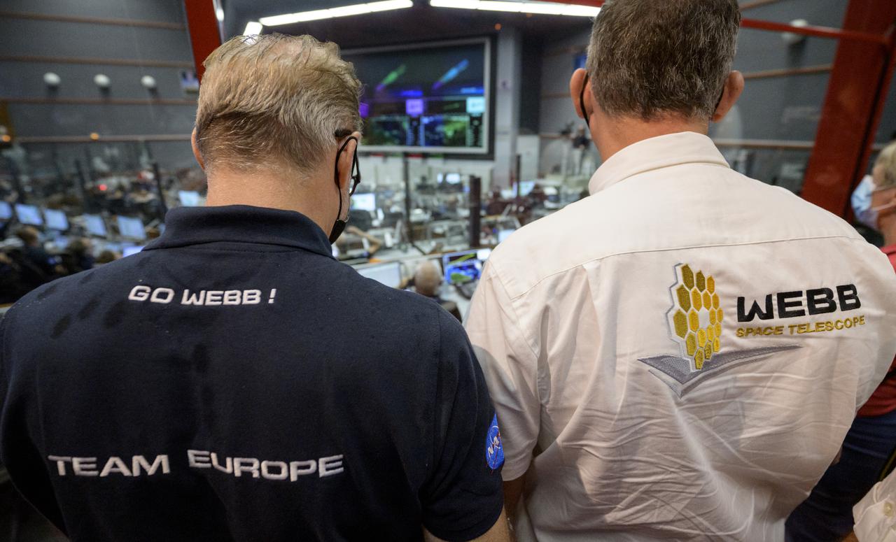 ESA (European Space Agency) Director-General Dr. Josef Aschbacher, left, and NASA Associate Administrator for the Science Mission Directorate Thomas Zurbuchen, monitor the progress of the Ariane 5 rocket delivering the James Webb Space Telescope into space, Saturday, Dec. 25, 2021, in the Jupiter Hall of the Guiana Space Centre in Kourou, French Guiana. The James Webb Space Telescope (sometimes called JWST or Webb) is a large infrared telescope with a 21.3 foot (6.5 meter) primary mirror. The observatory will study every phase of cosmic history—from within our solar system to the most distant observable galaxies in the early universe. Photo Credit: (NASA/Bill Ingalls)