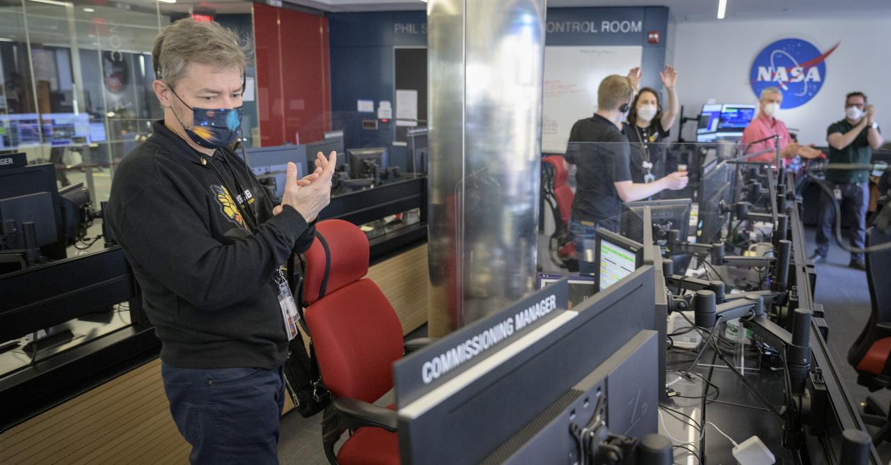 NASA James Webb Space Telescope Commissioning Manager John Durning, left, and engineering teams celebrate at the Space Telescope Science Institute in Baltimore as the second primary mirror wing of NASA’s James Webb Space Telescope unfolds, before beginning the process of latching the mirror wing into place, Saturday, Jan. 8, 2022. When fully latched, the infrared observatory will have completed its unprecedented process of unfolding in space to prepare for science operations. Webb will study every phase of cosmic history—from within our solar system to the most distant observable galaxies in the early universe. Photo Credit: (NASA/Bill Ingalls)