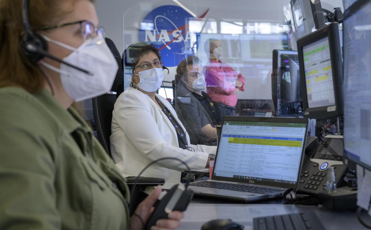 NASA James Webb Space Telescope Operations Controller Irma Quispe, 2nd from left, and other mission team members, monitor the progress of the Webb observatory as it’s second primary mirror wing is rotated into position, Saturday, Jan. 8, 2022, from NASA’s James Webb Space Telescope Mission Operations Center at the Space Telescope Science Institute in Baltimore. Webb, an infrared telescope with a 21.3-foot (6.5-meter) primary mirror, was folded up for launch and underwent an unprecedented deployment process to unfold in space. As NASA's next flagship observatory, Webb will study every phase of cosmic history—from within our solar system to the most distant observable galaxies in the early universe. Photo Credit: (NASA/Bill Ingalls)