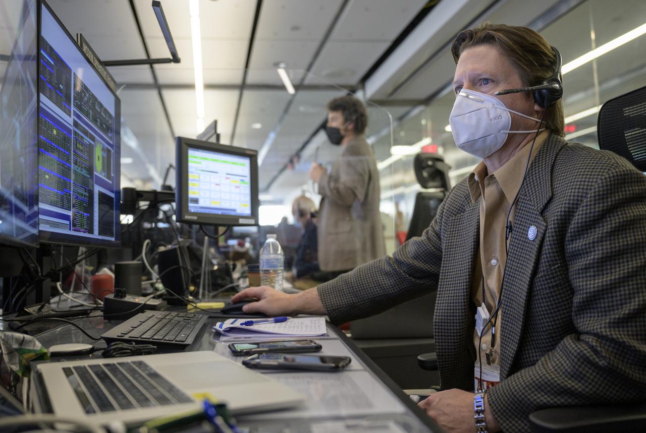 NASA James Webb Space Telescope Mission Operations Engineer Kenny McKenzie monitors the progress of Webb’s second primary mirror wing latching, Saturday, Jan. 8, 2022, in Baltimore. When fully latched, the infrared observatory will have completed its unprecedented process of unfolding in space to prepare for science operations. Webb will study every phase of cosmic history—from within our solar system to the most distant observable galaxies in the early universe. Photo Credit: (NASA/Bill Ingalls)