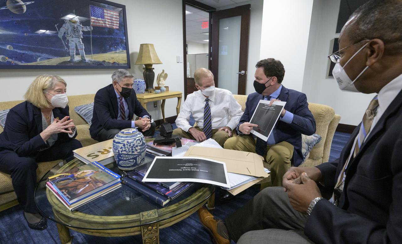NASA Deputy Administrator Pam Melroy, left, NASA Associate Administrator Bob Cabana, and NASA Administrator Bill Nelson are shown an early mirror alignment image from the James Webb Space Telescope, by NASA Webb Optical Telescope Element Manager Lee Feinberg, as NASA Program Director for the James Webb Space Telescope Program Greg Robinson, right, looks on, Monday, Feb., 7, 2022, at the Mary W. Jackson NASA Headquarters building in Washington. This engineering visual, which features 18 unfocused dots of light, demonstrates that the Webb team has successfully identified starlight through each of Webb’s 18 hexagonal mirror segments – the starting point in a months-long process to progressively align the segments into a single, precise mirror to prepare the telescope for science. Photo Credit: (NASA/Bill Ingalls)