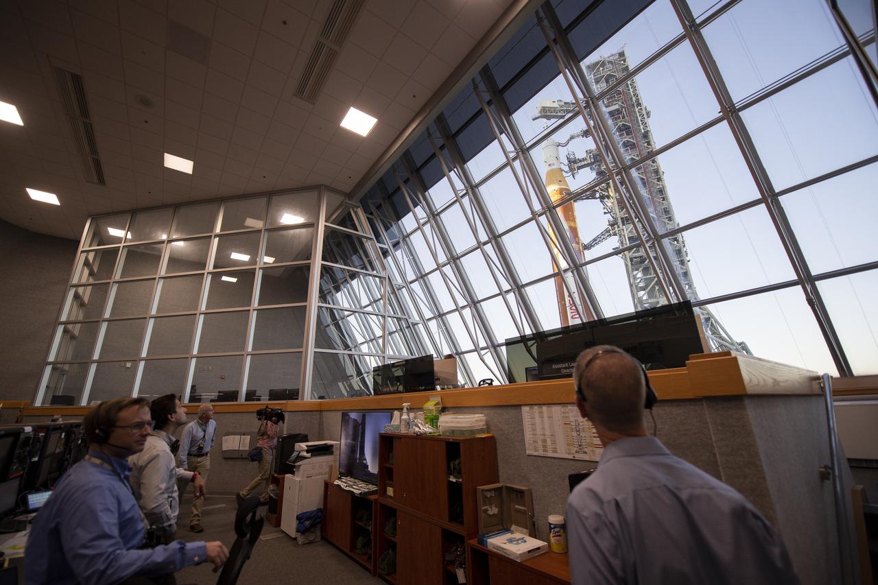 Members of the Artemis I launch team watch out the windows of Firing Room One of the Rocco A. Petrone Launch Control Center as NASA’s Space Launch System (SLS) rocket with the Orion spacecraft aboard atop a mobile launcher rolls out of High Bay 3 of the Vehicle Assembly Building for the first time to Launch Complex 39B, Thursday, March 17, 2022, at NASA’s Kennedy Space Center in Florida. Ahead of NASA’s Artemis I flight test, the fully stacked and integrated SLS rocket and Orion spacecraft will undergo a wet dress rehearsal at Launch Complex 39B to verify systems and practice countdown procedures for the first launch. Photo Credit: (NASA/Joel Kowsky)