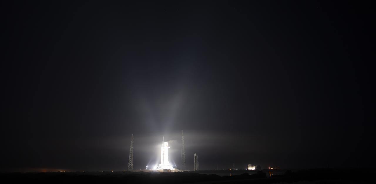 NASA’s Space Launch System (SLS) rocket with the Orion spacecraft aboard is seen illuminated by spotlights atop a mobile launcher at Launch Complex 39B, Friday, March 18, 2022, after being rollout out to the launch pad for the first time at NASA’s Kennedy Space Center in Florida. Ahead of NASA’s Artemis I flight test, the fully stacked and integrated SLS rocket and Orion spacecraft will undergo a wet dress rehearsal at Launch Complex 39B to verify systems and practice countdown procedures for the first launch. Photo Credit: (NASA/Joel Kowsky)