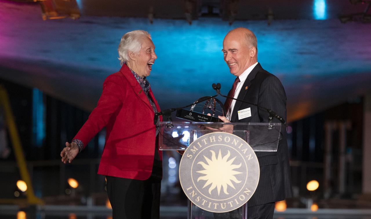 Wally Funk, left, accepts the 2022 Michael Collins Trophy for Lifetime Achievement from Christopher Browne, acting director of the Smithsonian’s National Air and Space Museum, right, Thursday, March 24, 2022, at the Smithsonian National Air and Space Museum’s Steven F. Udvar-Hazy center in Chantilly, Va. The Smithsonian National Air and Space Museum’s Michael Collins Trophy recognizes extraordinary accomplishments in aeronautics and spaceflight. Photo Credit: (NASA/Joel Kowsky)