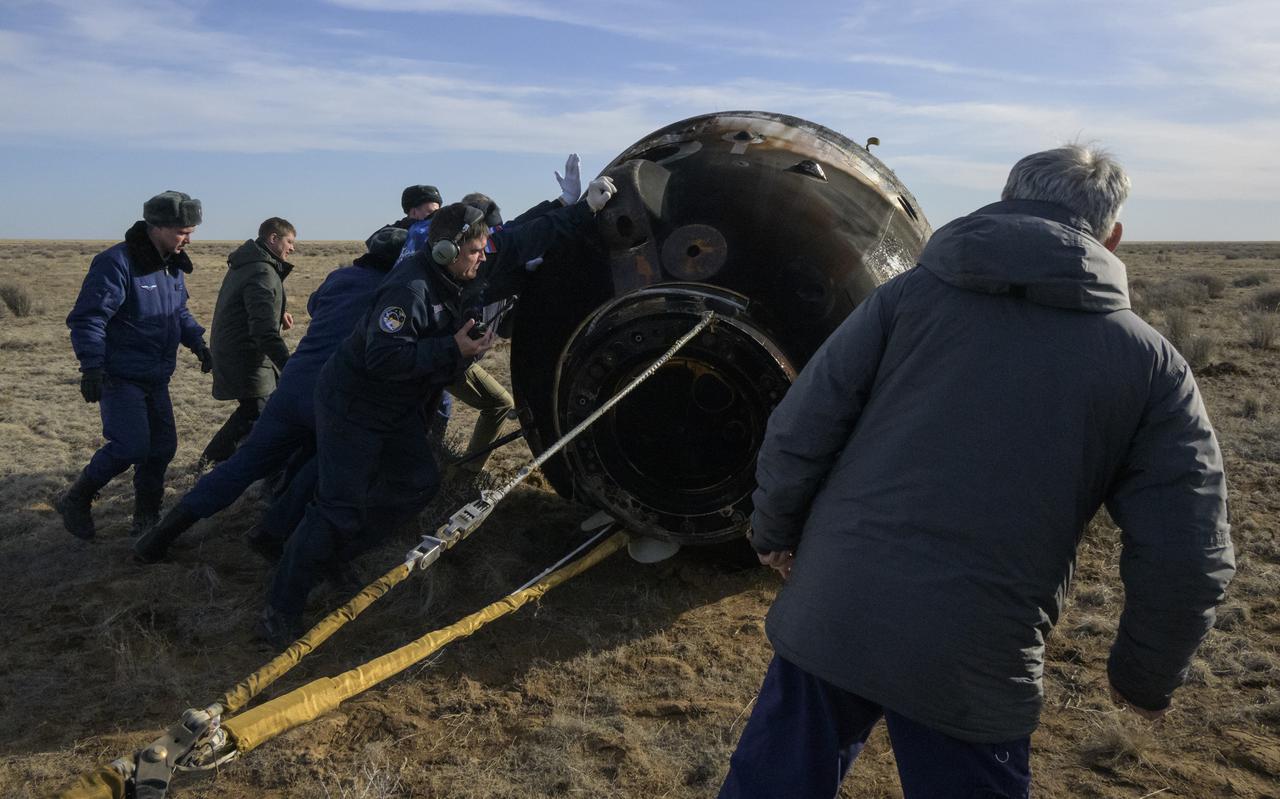 Russian Search and Rescue teams arrive at the Soyuz MS-19 spacecraft shortly after it landed in a remote area near the town of Zhezkazgan, Kazakhstan with Expedition 66 crew members Mark Vande Hei of NASA, and cosmonauts Pyotr Dubrov, and Anton Shkaplerov of Roscosmos, Wednesday, March 30, 2022. Vande Hei and Dubrov are returning to Earth after logging 355 days in space as members of Expeditions 64-66 aboard the International Space Station. For Vande Hei, his mission is the longest single spaceflight by a U.S. astronaut in history. Shkaplerov is returning after 176 days in space, serving as a Flight Engineer for Expedition 65 and commander of Expedition 66. Photo Credit: (NASA/Bill Ingalls)