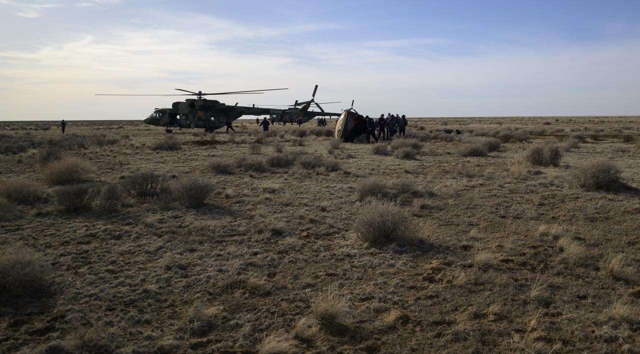 Russian Search and Rescue teams arrive at the Soyuz MS-19 spacecraft shortly after it landed in a remote area near the town of Zhezkazgan, Kazakhstan with Expedition 66 crew members Mark Vande Hei of NASA, and cosmonauts Pyotr Dubrov, and Anton Shkaplerov of Roscosmos, Wednesday, March 30, 2022. Vande Hei and Dubrov are returning to Earth after logging 355 days in space as members of Expeditions 64-66 aboard the International Space Station. For Vande Hei, his mission is the longest single spaceflight by a U.S. astronaut in history. Shkaplerov is returning after 176 days in space, serving as a Flight Engineer for Expedition 65 and commander of Expedition 66. Photo Credit: (NASA/Bill Ingalls)