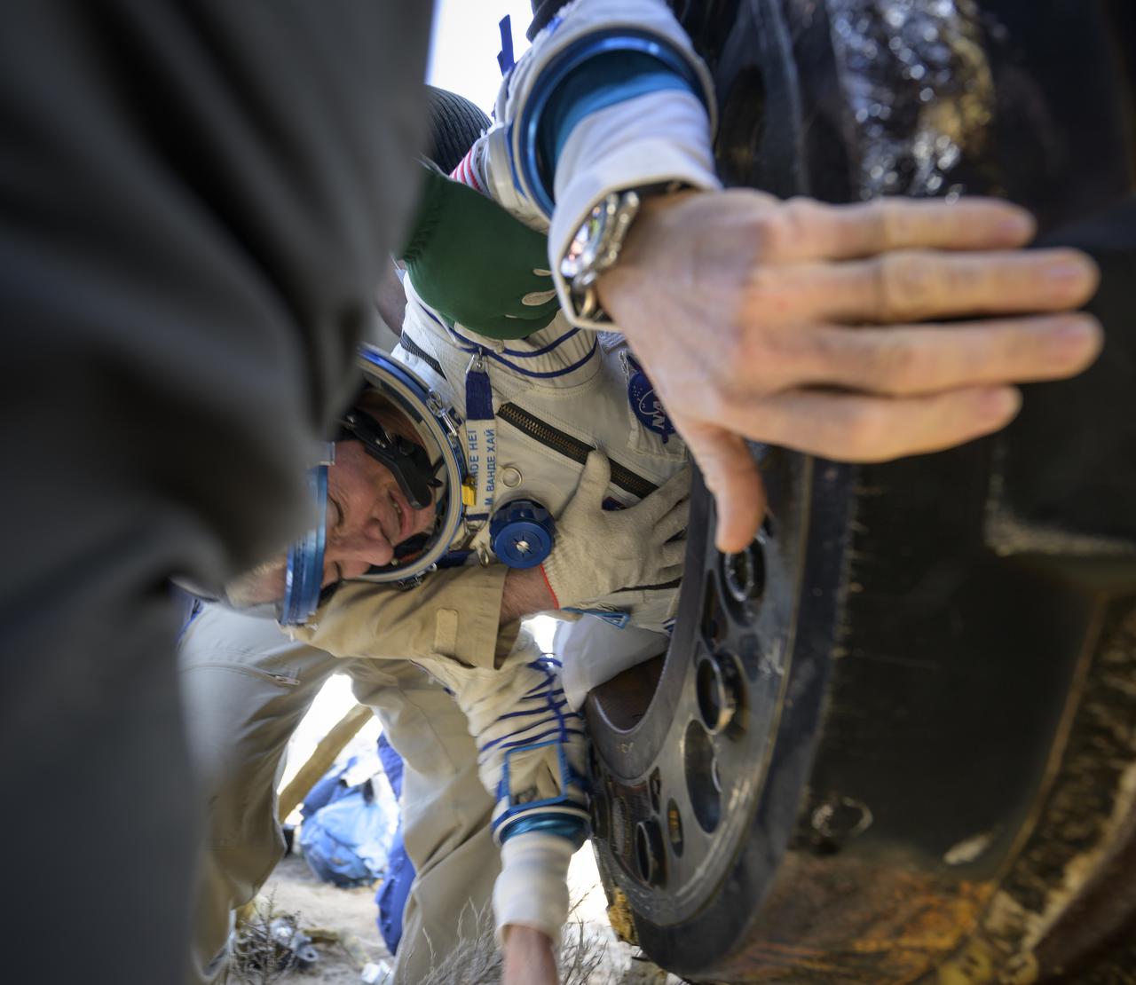Expedition 66 NASA astronaut Mark Vande Hei is helped out of the Soyuz MS-19 spacecraft just minutes after he and Russian cosmonauts Pyotr Dubrov and Anton Shkaplerov, landed in a remote area near the town of Zhezkazgan, Kazakhstan on Wednesday, March 30, 2022. Vande Hei and Dubrov are returning to Earth after logging 355 days in space as members of Expeditions 64-66 aboard the International Space Station. For Vande Hei, his mission is the longest single spaceflight by a U.S. astronaut in history. Shkaplerov is returning after 176 days in space, serving as a Flight Engineer for Expedition 65 and commander of Expedition 66. Photo Credit: (NASA/Bill Ingalls)