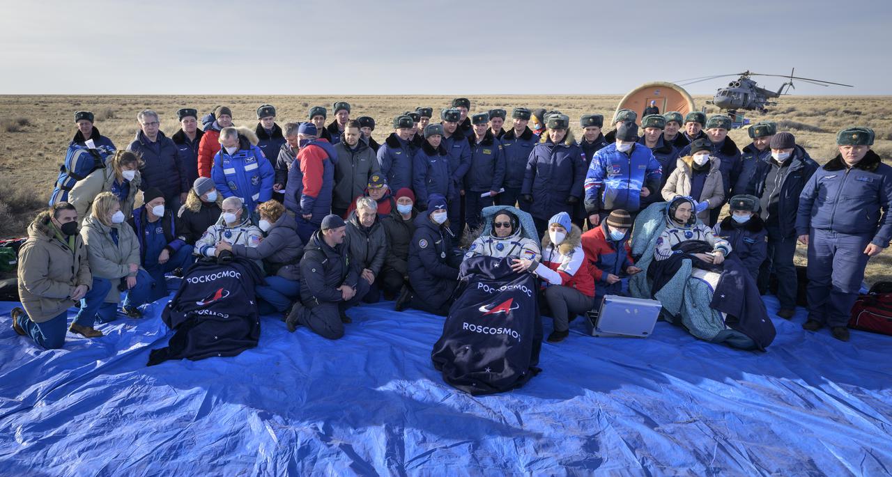 Expedition 66 crew members Mark Vande Hei of NASA, left, and cosmonauts Anton Shkaplerov, center, and Pyotr Dubrov of Roscosmos, sit in chairs outside the Soyuz MS-19 spacecraft after they landed in a remote area near the town of Zhezkazgan, Kazakhstan on Wednesday, March 30, 2022. Vande Hei and Dubrov are returning to Earth after logging 355 days in space as members of Expeditions 64-66 aboard the International Space Station. For Vande Hei, his mission is the longest single spaceflight by a U.S. astronaut in history. Shkaplerov is returning after 176 days in space, serving as a Flight Engineer for Expedition 65 and commander of Expedition 66. Photo Credit: (NASA/Bill Ingalls)