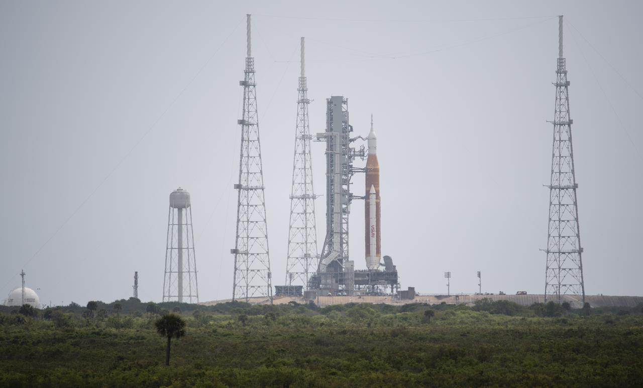 NASA’s Space Launch System (SLS) rocket with the Orion spacecraft aboard is seen atop a mobile launcher at Launch Complex 39B, Saturday, April 2, 2022, as the Artemis I launch team conducts the wet dress rehearsal test at NASA’s Kennedy Space Center in Florida. Ahead of NASA’s Artemis I flight test, the wet dress rehearsal will run the Artemis I launch team through operations to load propellant, conduct a full launch countdown, demonstrate the ability to recycle the countdown clock, and drain the tanks to practice timelines and procedures for launch.  Photo Credit: (NASA/Joel Kowsky)