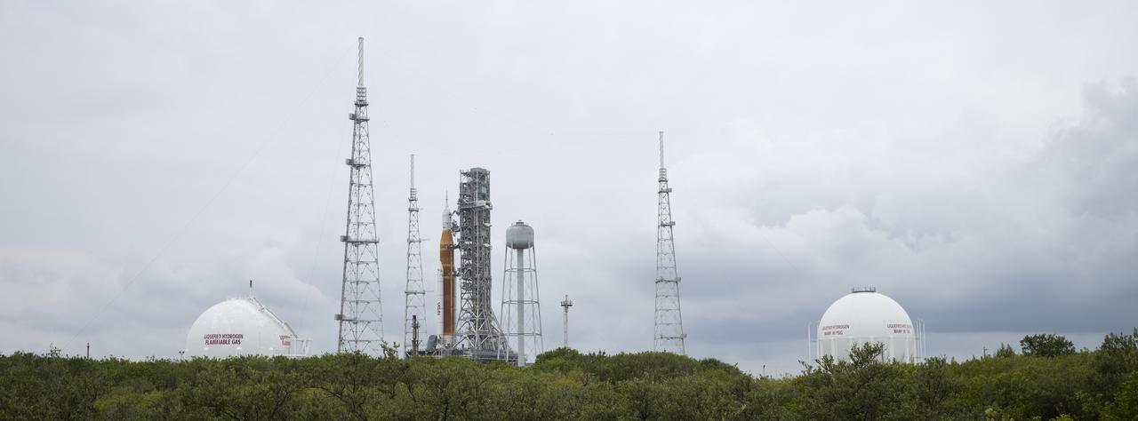 NASA’s Space Launch System (SLS) rocket with the Orion spacecraft aboard is seen atop a mobile launcher at Launch Complex 39B, Saturday, April 2, 2022, as the Artemis I launch team conducts the wet dress rehearsal test at NASA’s Kennedy Space Center in Florida. Ahead of NASA’s Artemis I flight test, the wet dress rehearsal will run the Artemis I launch team through operations to load propellant, conduct a full launch countdown, demonstrate the ability to recycle the countdown clock, and drain the tanks to practice timelines and procedures for launch.  Photo Credit: (NASA/Joel Kowsky)