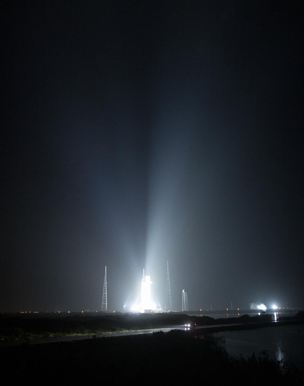 NASA’s Space Launch System (SLS) rocket with the Orion spacecraft aboard is seen atop a mobile launcher at Launch Complex 39B illuminated by spotlights, Saturday, April 2, 2022, as the Artemis I launch team conducts the wet dress rehearsal test at NASA’s Kennedy Space Center in Florida. Ahead of NASA’s Artemis I flight test, the wet dress rehearsal will run the Artemis I launch team through operations to load propellant, conduct a full launch countdown, demonstrate the ability to recycle the countdown clock, and drain the tanks to practice timelines and procedures for launch.  Photo Credit: (NASA/Joel Kowsky)