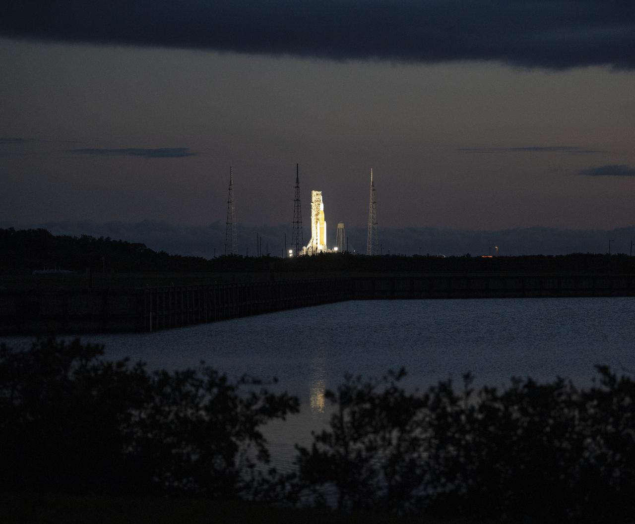 NASA’s Space Launch System (SLS) rocket with the Orion spacecraft aboard is seen at sunrise atop a mobile launcher at Launch Complex 39B, Sunday, April 3, 2022, as the Artemis I launch team conducts the wet dress rehearsal test at NASA’s Kennedy Space Center in Florida. Ahead of NASA’s Artemis I flight test, the wet dress rehearsal will run the Artemis I launch team through operations to load propellant, conduct a full launch countdown, demonstrate the ability to recycle the countdown clock, and drain the tanks to practice timelines and procedures for launch.  Photo Credit: (NASA/Joel Kowsky)