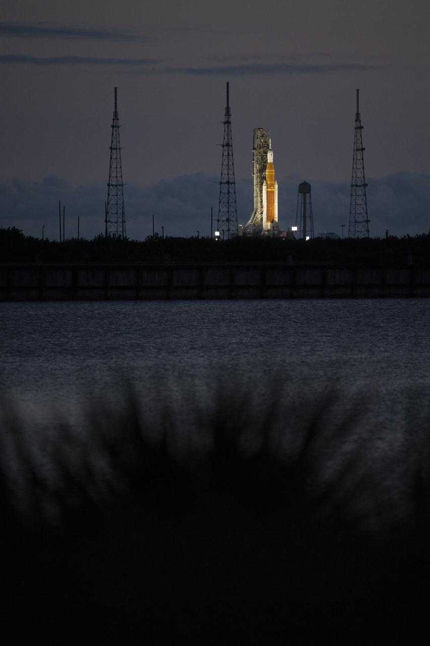 NASA’s Space Launch System (SLS) rocket with the Orion spacecraft aboard is seen at sunrise atop a mobile launcher at Launch Complex 39B, Sunday, April 3, 2022, as the Artemis I launch team conducts the wet dress rehearsal test at NASA’s Kennedy Space Center in Florida. Ahead of NASA’s Artemis I flight test, the wet dress rehearsal will run the Artemis I launch team through operations to load propellant, conduct a full launch countdown, demonstrate the ability to recycle the countdown clock, and drain the tanks to practice timelines and procedures for launch.  Photo Credit: (NASA/Joel Kowsky)