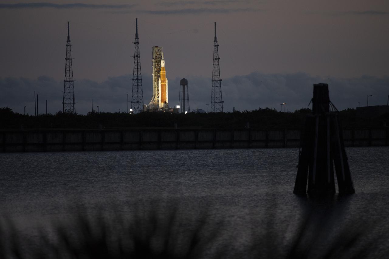 NASA’s Space Launch System (SLS) rocket with the Orion spacecraft aboard is seen at sunrise atop a mobile launcher at Launch Complex 39B, Sunday, April 3, 2022, as the Artemis I launch team conducts the wet dress rehearsal test at NASA’s Kennedy Space Center in Florida. Ahead of NASA’s Artemis I flight test, the wet dress rehearsal will run the Artemis I launch team through operations to load propellant, conduct a full launch countdown, demonstrate the ability to recycle the countdown clock, and drain the tanks to practice timelines and procedures for launch.  Photo Credit: (NASA/Joel Kowsky)