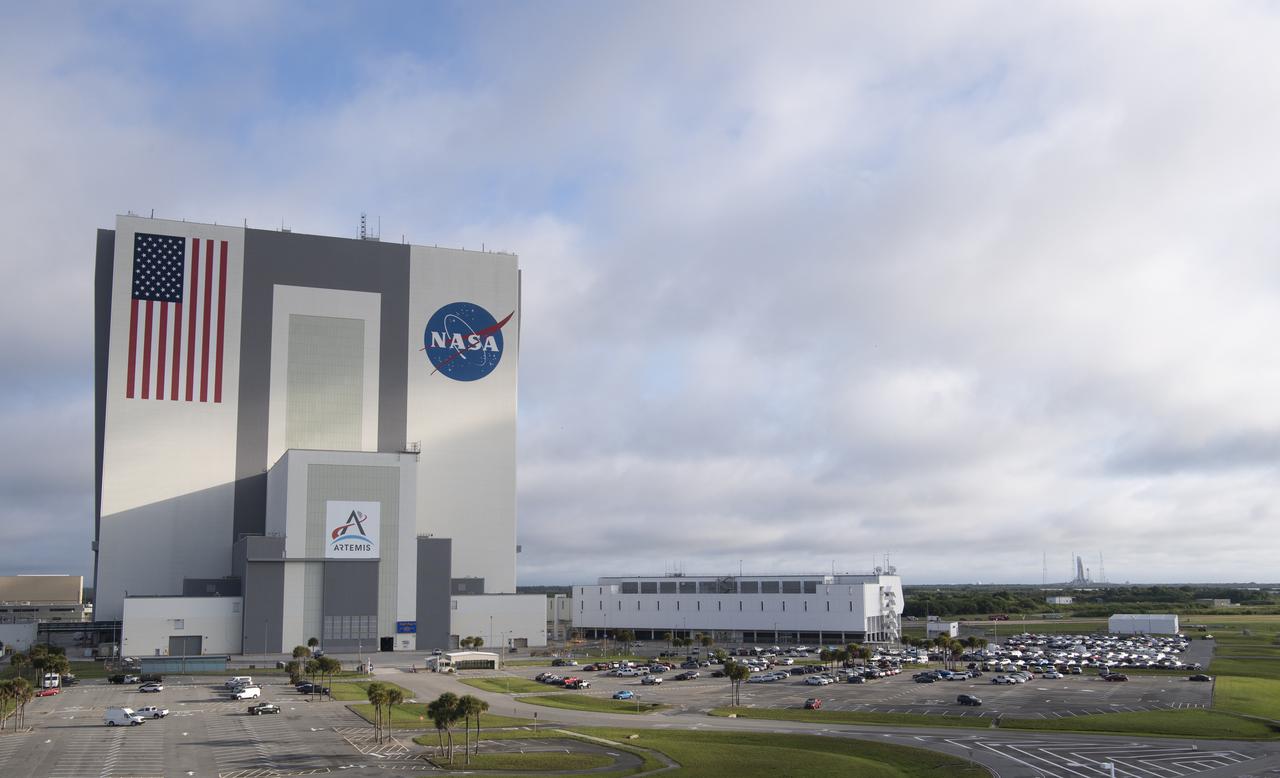 NASA’s Space Launch System (SLS) rocket with the Orion spacecraft aboard is seen atop a mobile launcher at Launch Complex 39Bin this view of the Vehicle Assembly Building and the Rocco A. Petrone Launch Control Center, Sunday, April 3, 2022, as the Artemis I launch team conducts the wet dress rehearsal test at NASA’s Kennedy Space Center in Florida. Ahead of NASA’s Artemis I flight test, the wet dress rehearsal will run the Artemis I launch team through operations to load propellant, conduct a full launch countdown, demonstrate the ability to recycle the countdown clock, and drain the tanks to practice timelines and procedures for launch.  Photo Credit: (NASA/Joel Kowsky)