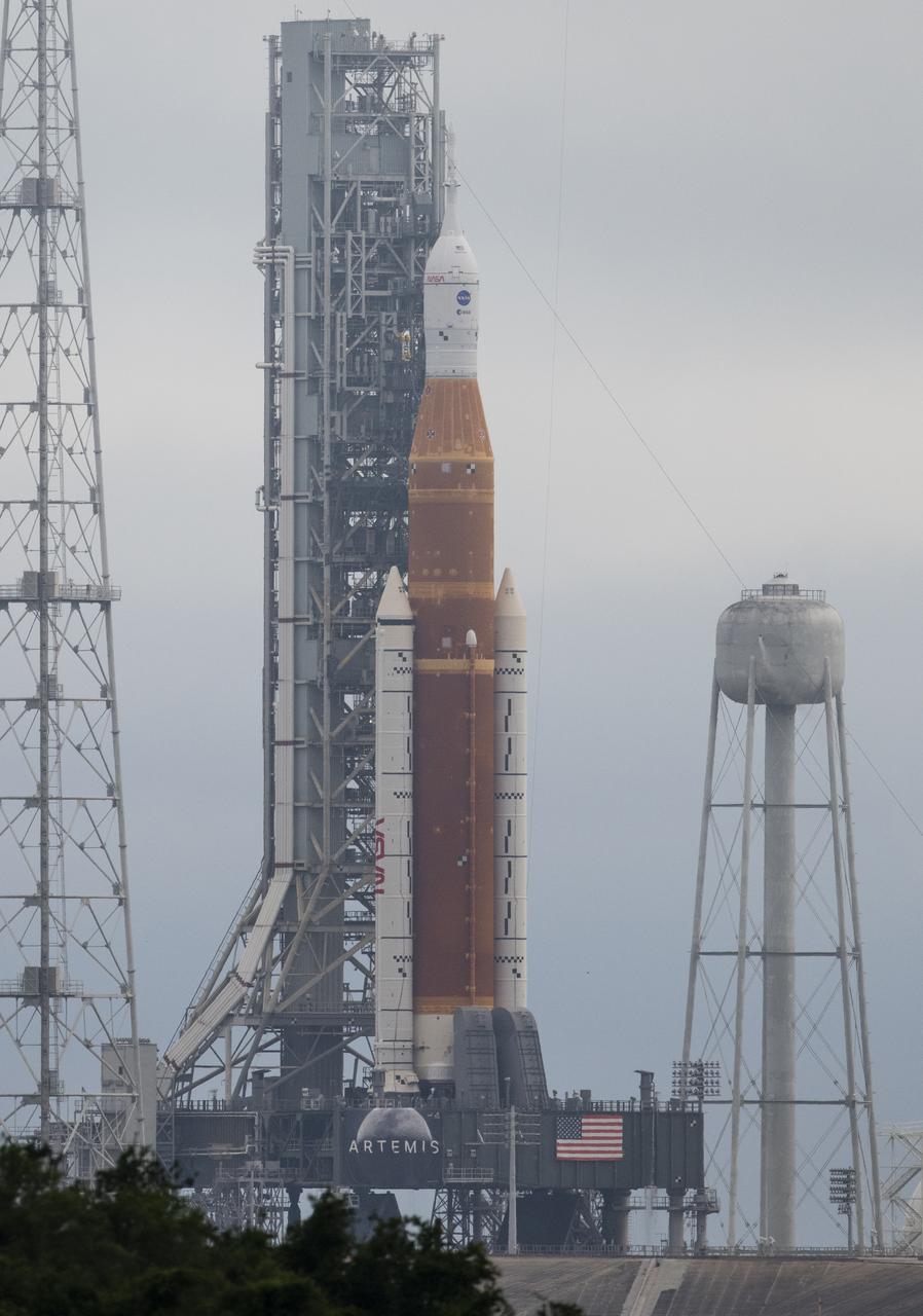 NASA’s Space Launch System (SLS) rocket with the Orion spacecraft aboard is seen atop a mobile launcher at Launch Complex 39B, Sunday, April 3, 2022, as the Artemis I launch team conducts the wet dress rehearsal test at NASA’s Kennedy Space Center in Florida. Ahead of NASA’s Artemis I flight test, the wet dress rehearsal will run the Artemis I launch team through operations to load propellant, conduct a full launch countdown, demonstrate the ability to recycle the countdown clock, and drain the tanks to practice timelines and procedures for launch.  Photo Credit: (NASA/Joel Kowsky)