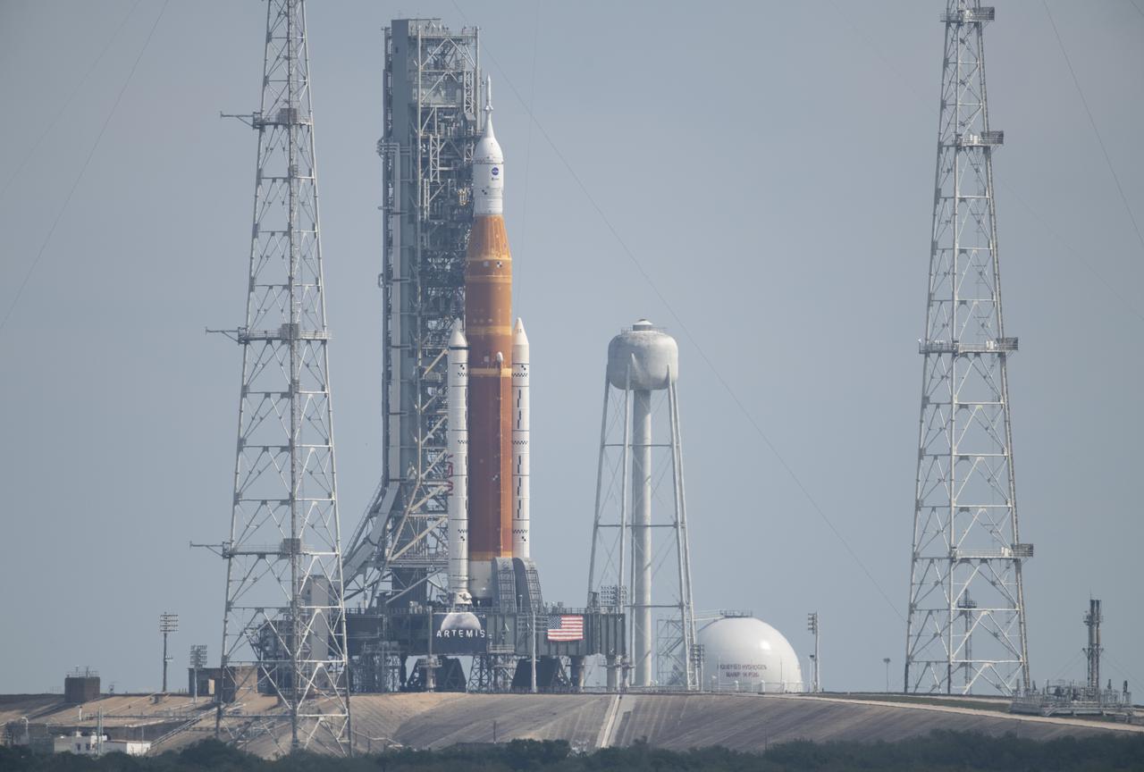 NASA’s Space Launch System (SLS) rocket with the Orion spacecraft aboard is seen atop a mobile launcher at Launch Complex 39B, Sunday, April 3, 2022, as the Artemis I launch team conducts the wet dress rehearsal test at NASA’s Kennedy Space Center in Florida. Ahead of NASA’s Artemis I flight test, the wet dress rehearsal will run the Artemis I launch team through operations to load propellant, conduct a full launch countdown, demonstrate the ability to recycle the countdown clock, and drain the tanks to practice timelines and procedures for launch.  Photo Credit: (NASA/Joel Kowsky)