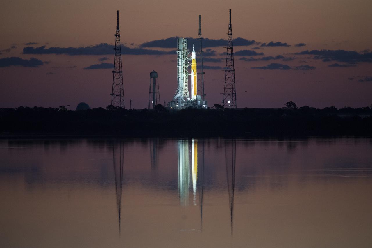 NASA’s Space Launch System (SLS) rocket with the Orion spacecraft aboard is seen at sunrise atop a mobile launcher at Launch Complex 39B, Monday, April 4, 2022, as the Artemis I launch team conducts the wet dress rehearsal test at NASA’s Kennedy Space Center in Florida. Ahead of NASA’s Artemis I flight test, the wet dress rehearsal will run the Artemis I launch team through operations to load propellant, conduct a full launch countdown, demonstrate the ability to recycle the countdown clock, and drain the tanks to practice timelines and procedures for launch.  Photo Credit: (NASA/Joel Kowsky)