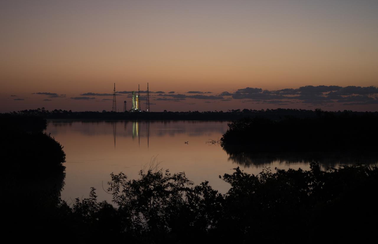 NASA’s Space Launch System (SLS) rocket with the Orion spacecraft aboard is seen at sunrise atop a mobile launcher at Launch Complex 39B, Monday, April 4, 2022, as the Artemis I launch team conducts the wet dress rehearsal test at NASA’s Kennedy Space Center in Florida. Ahead of NASA’s Artemis I flight test, the wet dress rehearsal will run the Artemis I launch team through operations to load propellant, conduct a full launch countdown, demonstrate the ability to recycle the countdown clock, and drain the tanks to practice timelines and procedures for launch.  Photo Credit: (NASA/Joel Kowsky)