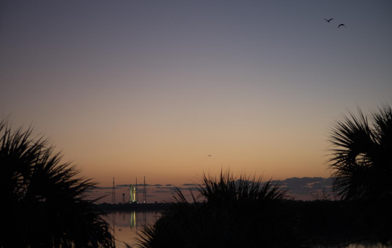 NASA’s Space Launch System (SLS) rocket with the Orion spacecraft aboard is seen at sunrise atop a mobile launcher at Launch Complex 39B, Monday, April 4, 2022, as the Artemis I launch team conducts the wet dress rehearsal test at NASA’s Kennedy Space Center in Florida. Ahead of NASA’s Artemis I flight test, the wet dress rehearsal will run the Artemis I launch team through operations to load propellant, conduct a full launch countdown, demonstrate the ability to recycle the countdown clock, and drain the tanks to practice timelines and procedures for launch.  Photo Credit: (NASA/Joel Kowsky)