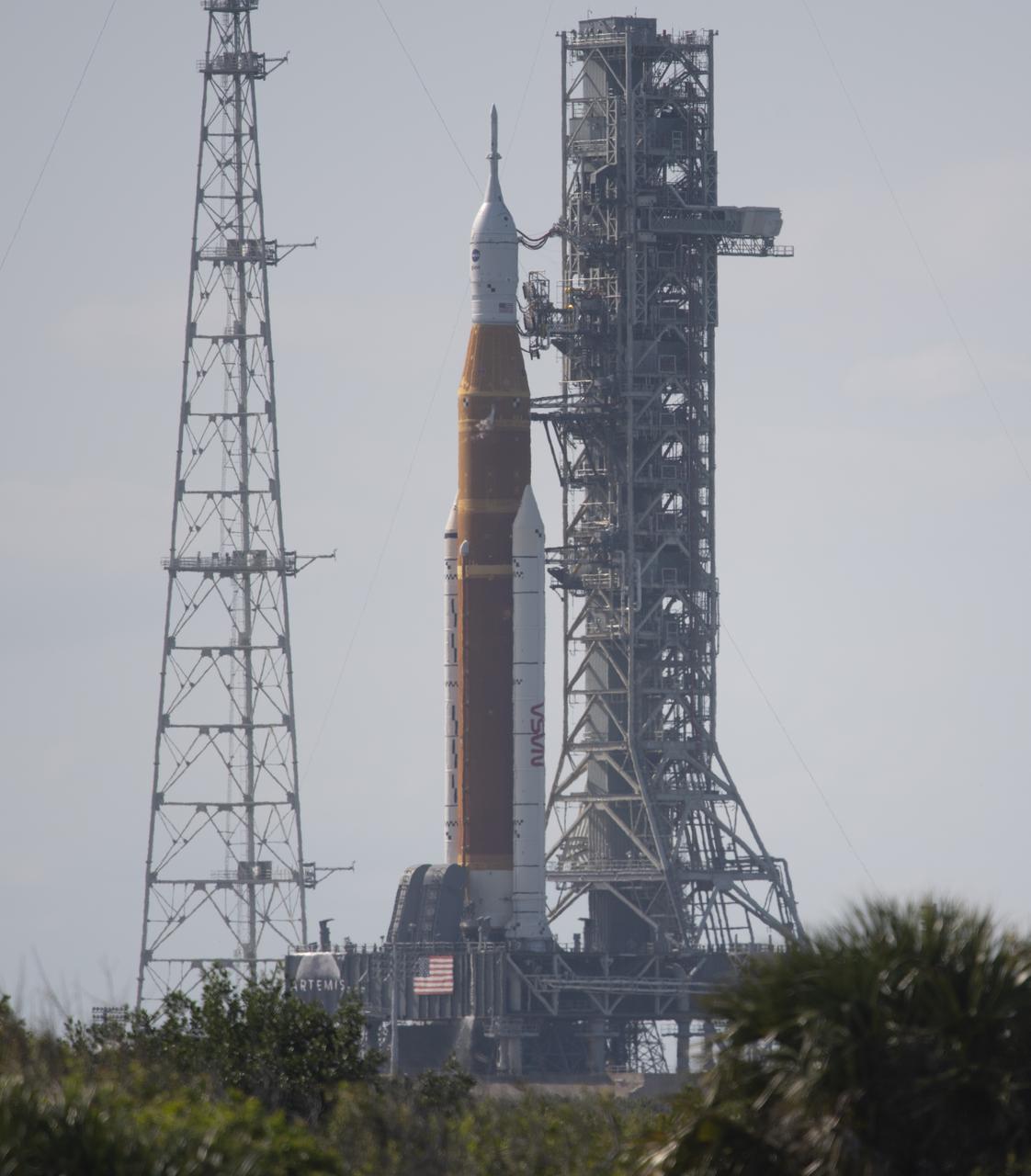 NASA’s Space Launch System (SLS) rocket with the Orion spacecraft aboard is seen atop a mobile launcher at Launch Complex 39B, Monday, April 4, 2022, as the Artemis I launch team conducts the wet dress rehearsal test at NASA’s Kennedy Space Center in Florida. Ahead of NASA’s Artemis I flight test, the wet dress rehearsal will run the Artemis I launch team through operations to load propellant, conduct a full launch countdown, demonstrate the ability to recycle the countdown clock, and drain the tanks to practice timelines and procedures for launch.  Photo Credit: (NASA/Joel Kowsky)