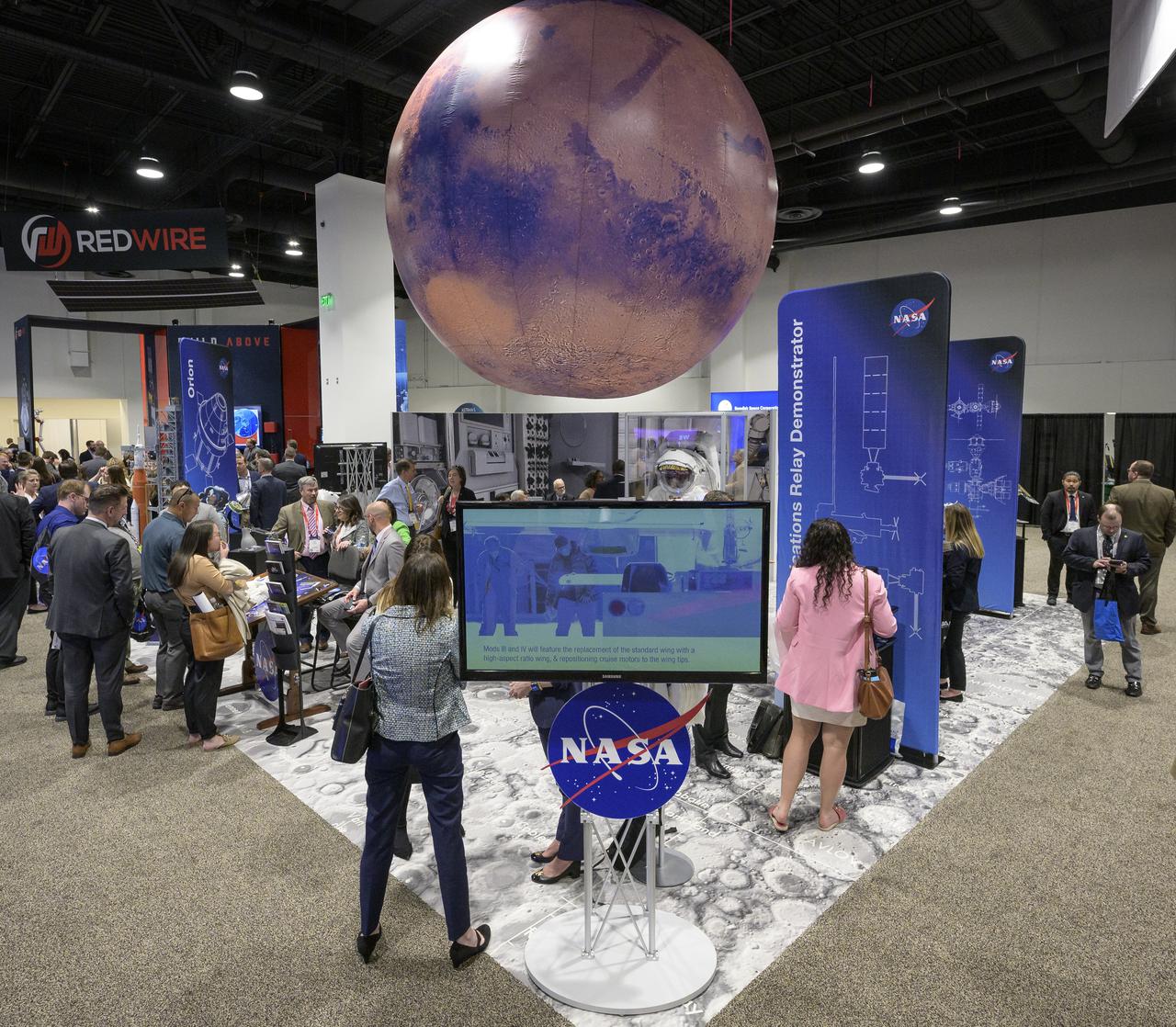 Attendees visit the NASA Exhibit area during the 37th Space Symposium, Tuesday, April 5, 2022, in Colorado Springs, Colorado. Photo Credit: (NASA/Bill Ingalls)
