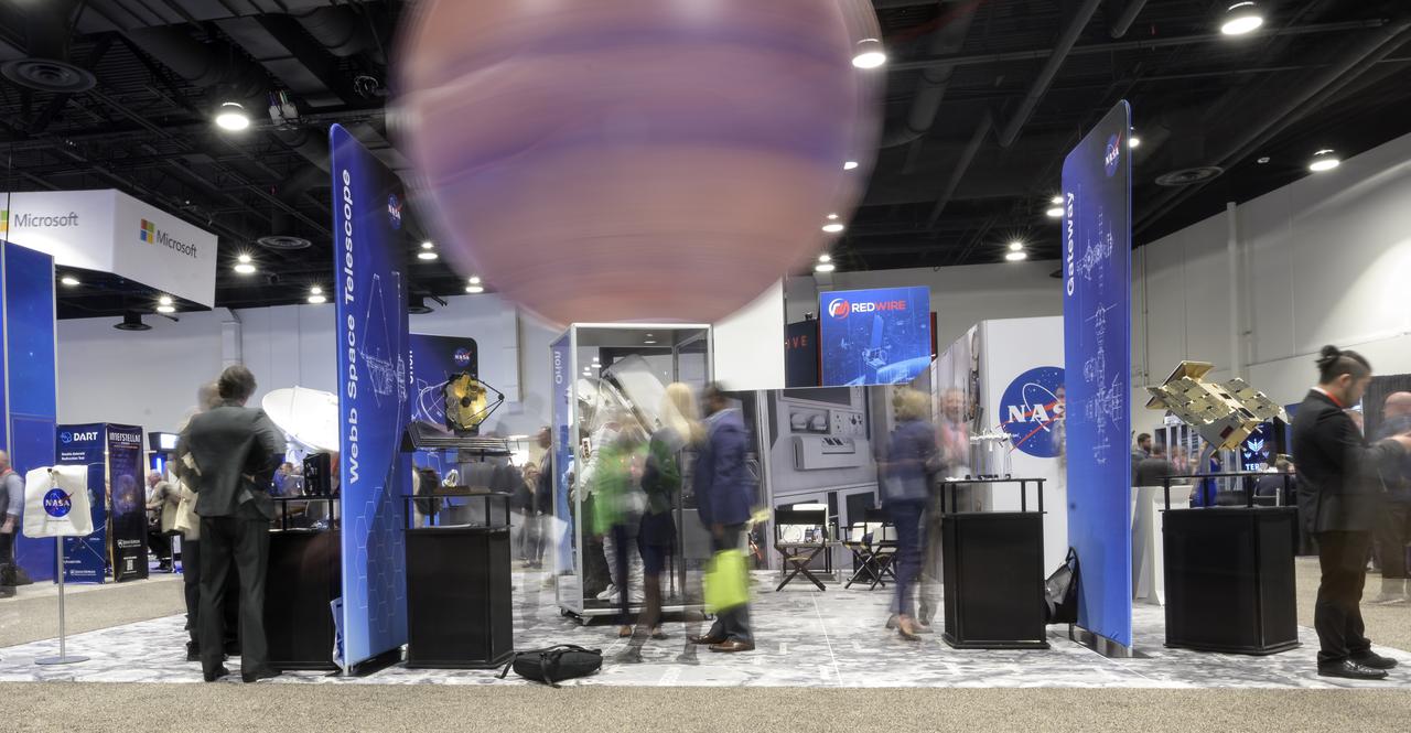The NASA Exhibit area is seen in this 10 second exposure photograph during the 37th Space Symposium, Tuesday, April 5, 2022, in Colorado Springs, Colorado. Photo Credit: (NASA/Bill Ingalls)
