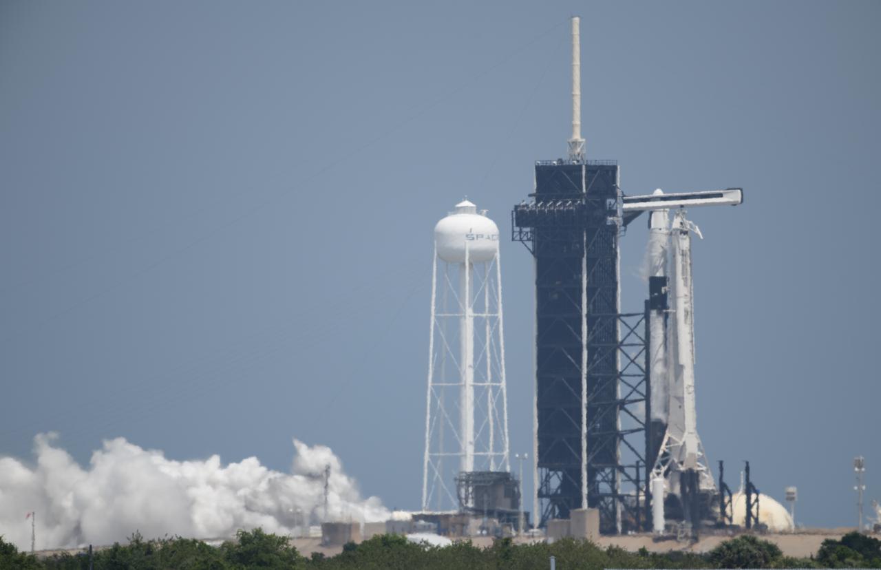 A SpaceX Falcon 9 rocket with the company's Crew Dragon spacecraft aboard is seen on the launch pad at Launch Complex 39A during a brief static fire test ahead of Axiom Mission 1 (Ax-1), Wednesday, April 6, 2022, at NASA’s Kennedy Space Center in Florida. The Ax-1 mission is the first private astronaut mission to the International Space Station.  Ax-1 crew members Commander Michael López-Alegría of Spain and the United States, Pilot Larry Connor of the United States, and Mission Specialists Eytan Stibbe of Israel, and Mark Pathy of Canada are scheduled to launch on no earlier than March 20, from Launch Complex 39A at the Kennedy Space Center. Photo Credit: (NASA/Joel Kowsky)