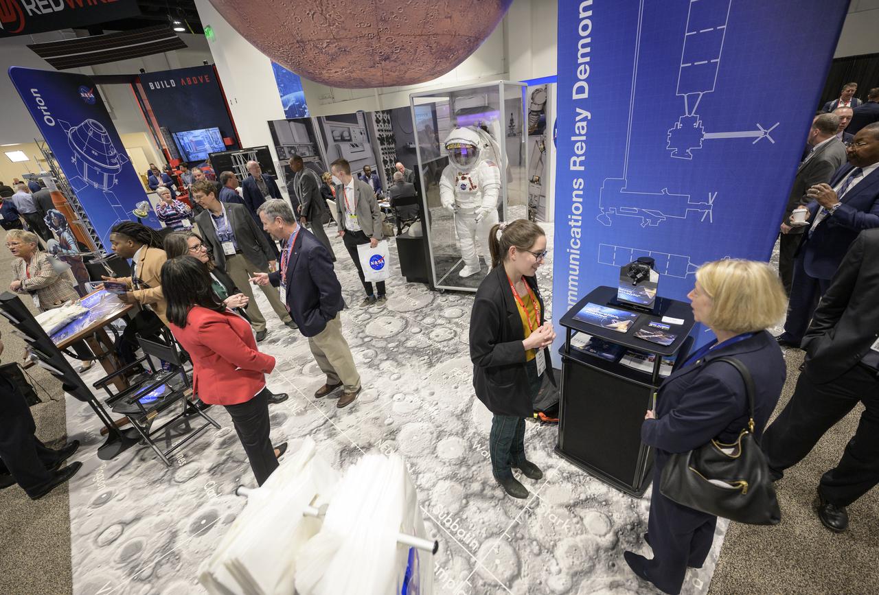 NASA Deputy Administrator Pam Melroy, lower right, meets with colleagues at the NASA Exhibit area during the 37th Space Symposium, Wednesday, April 6, 2022, in Colorado Springs, Colorado. Photo Credit: (NASA/Bill Ingalls)