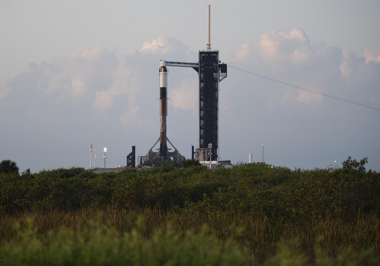 A SpaceX Falcon 9 rocket with the company's Crew Dragon spacecraft aboard is seen at sunrise on the launch pad at Launch Complex 39A as preparations continue for Axiom Mission 1 (Ax-1), Thursday, April 7, 2022, at NASA’s Kennedy Space Center in Florida. The Ax-1 mission is the first private astronaut mission to the International Space Station.  Ax-1 crew members Commander Michael López-Alegría of Spain and the United States, Pilot Larry Connor of the United States, and Mission Specialists Eytan Stibbe of Israel, and Mark Pathy of Canada are scheduled to launch on April 8 at 11:17 a.m. EDT, from Launch Complex 39A at the Kennedy Space Center. Photo Credit: (NASA/Joel Kowsky)