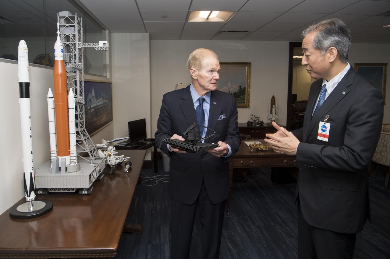 NASA Administrator Bill Nelson, left, shows some of the models of spacecraft and satellites in his office, to President of the Japan Aerospace Exploration Agency (JAXA), Hiroshi Yamakawa, during a meeting, Thursday, April 7, 2022, at NASA Headquarters in Washington DC. Photo Credit: (NASA/Aubrey Gemignani)