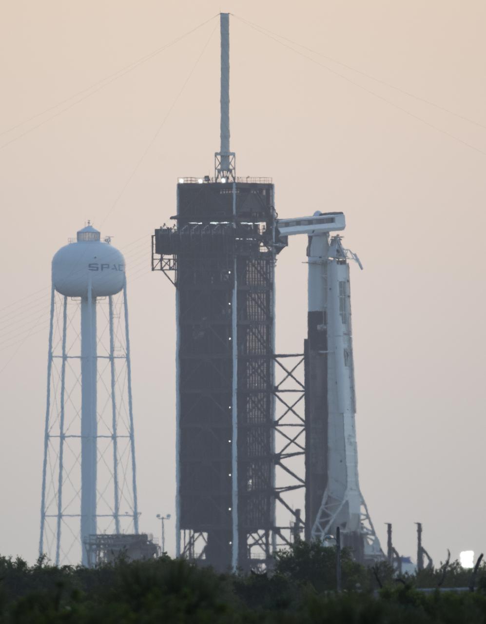 A SpaceX Falcon 9 rocket with the company's Crew Dragon spacecraft aboard is seen at sunrise on the launch pad at Launch Complex 39A as preparations continue for Axiom Mission 1 (Ax-1), Friday, April 8, 2022, at NASA’s Kennedy Space Center in Florida. The Ax-1 mission is the first private astronaut mission to the International Space Station. Ax-1 crew members Commander Michael López-Alegría of Spain and the United States, Pilot Larry Connor of the United States, and Mission Specialists Eytan Stibbe of Israel, and Mark Pathy of Canada are scheduled to launch at 11:17 a.m. EDT from Launch Complex 39A at the Kennedy Space Center. Photo Credit: (NASA/Joel Kowsky)