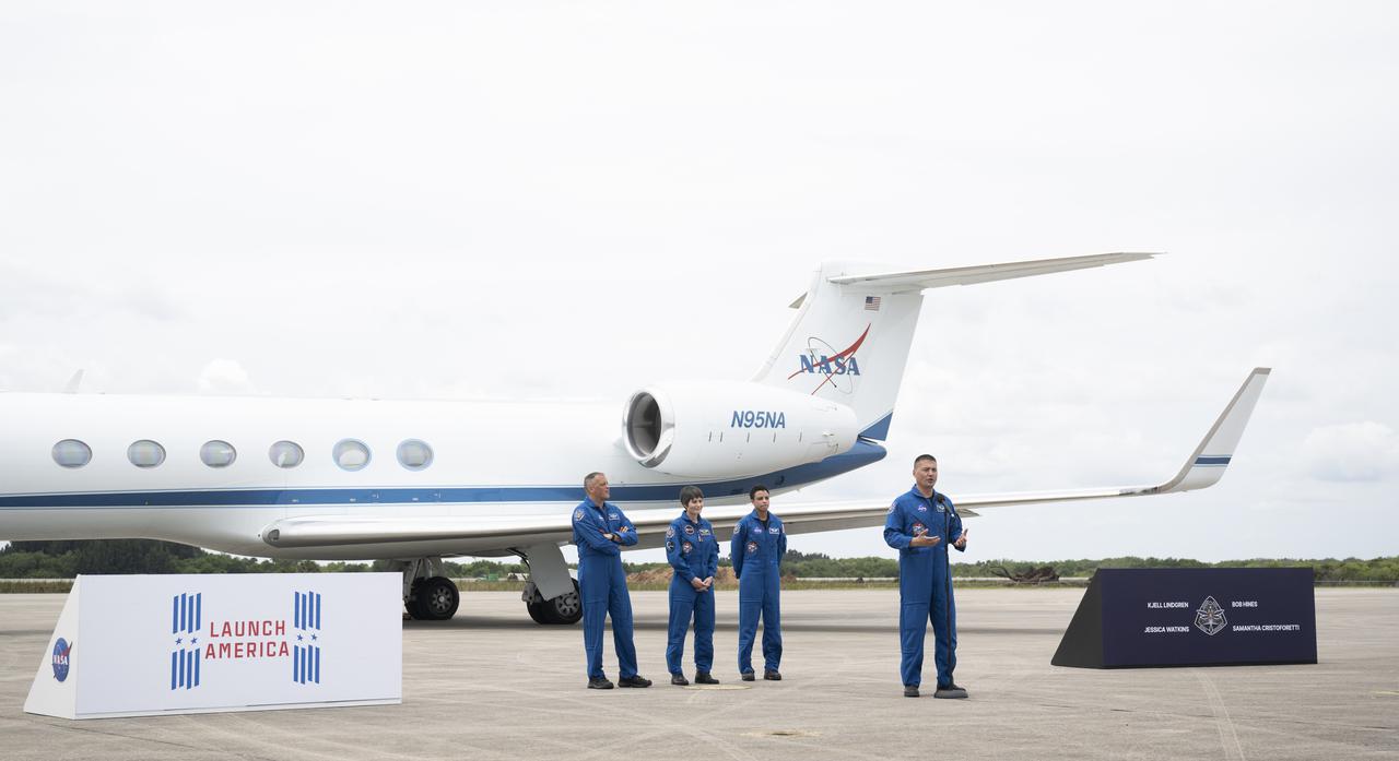 NASA astronauts Kjell Lindgren, right, speaks to members of the media after arriving at the Launch and Landing Facility at NASA’s Kennedy Space Center with fellow crewmates NASA astronaut Robert Hines, left, ESA (European Space Agency) astronaut Samantha Cristoforetti, second from left, and NASA astronaut Jessica Watkins, second from right, ahead of SpaceX’s Crew-4 mission, Monday, April 18, 2022, in Florida. NASA’s SpaceX Crew-4 mission is the fourth crew rotation mission of the SpaceX Crew Dragon spacecraft and Falcon 9 rocket to the International Space Station as part of the agency’s Commercial Crew Program. Lindgren, Hines, Watkins, and Cristoforetti are scheduled to launch at April 23 at 5:26 a.m. EDT, from Launch Complex 39A at the Kennedy Space Center. Photo Credit: (NASA/Joel Kowsky)