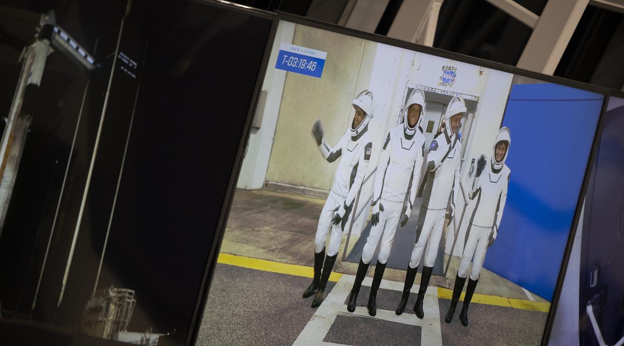NASA astronauts Jessica Watkins, left, Robert Hines, second from left, Kjell Lindgren, second from right, and ESA (European Space Agency) astronaut Samantha Cristoforetti, right, are seen on a monitor in firing room four of the Rocco A. Petrone Launch Control Center as they walk out of the Neil A. Armstrong Operations and Checkout Building during a dress rehearsal in preparation for the launch of a SpaceX Falcon 9 rocket carrying the company's Crew Dragon spacecraft on NASA’s SpaceX Crew-4 mission, Wednesday, April 20, 2022, at NASA’s Kennedy Space Center in Florida. NASA’s SpaceX Crew-4 mission is the fourth crew rotation mission of the SpaceX Crew Dragon spacecraft and Falcon 9 rocket to the International Space Station as part of the agency’s Commercial Crew Program. Lindgren, Hines, Watkins, and Cristoforetti are scheduled to launch on April 23 at 5:26 a.m. EDT, from Launch Complex 39A at the Kennedy Space Center. Photo Credit: (NASA/Joel Kowsky)