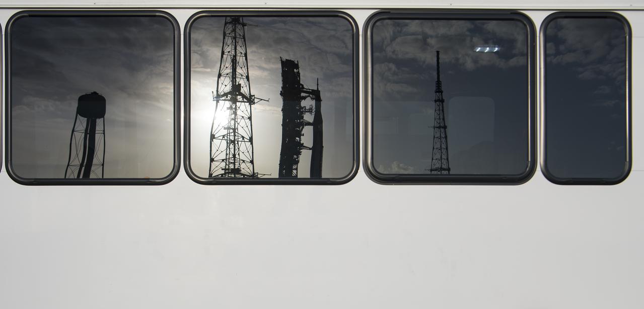NASA’s Space Launch System (SLS) rocket with the Orion spacecraft aboard is seen in a reflection in the windows of a shuttle bus, Thursday, April 21, 2022, at NASA’s Kennedy Space Center in Florida. Photo Credit: (NASA/Aubrey Gemignani)