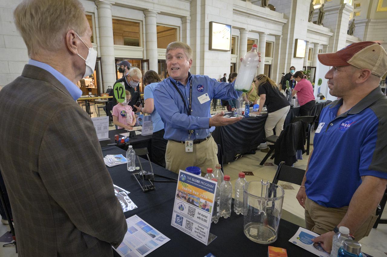 NASA Administrator Bill Nelson, left, talks with NASA team members about Earth Day during his tour of NASA hands-on exhibits inside Union Station in Washington, Friday, April 22, 2022. Photo Credit: (NASA/Bill Ingalls)