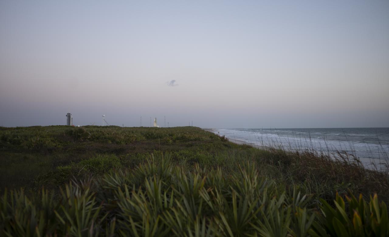 NASA’s Space Launch System (SLS) rocket with the Orion spacecraft aboard is seen atop a mobile launcher at Launch Complex 39B, right, as a SpaceX Falcon 9 rocket with the company's Crew Dragon spacecraft onboard is seen on the launch pad at Launch Complex 39A, left, as preparations continue for the Crew-4 mission, Monday, April 25, 2022, at NASA’s Kennedy Space Center in Florida. NASA’s SpaceX Crew-4 mission is the fourth crew rotation mission of the SpaceX Crew Dragon spacecraft and Falcon 9 rocket to the International Space Station as part of the agency’s Commercial Crew Program. NASA astronauts Kjell Lindgren, Robert Hines, Jessica Watkins, and ESA (European Space Agency) astronaut Samantha Cristoforetti are scheduled to launch no earlier than April 27 from Launch Complex 39A at the Kennedy Space Center. Photo Credit: (NASA/Joel Kowsky)