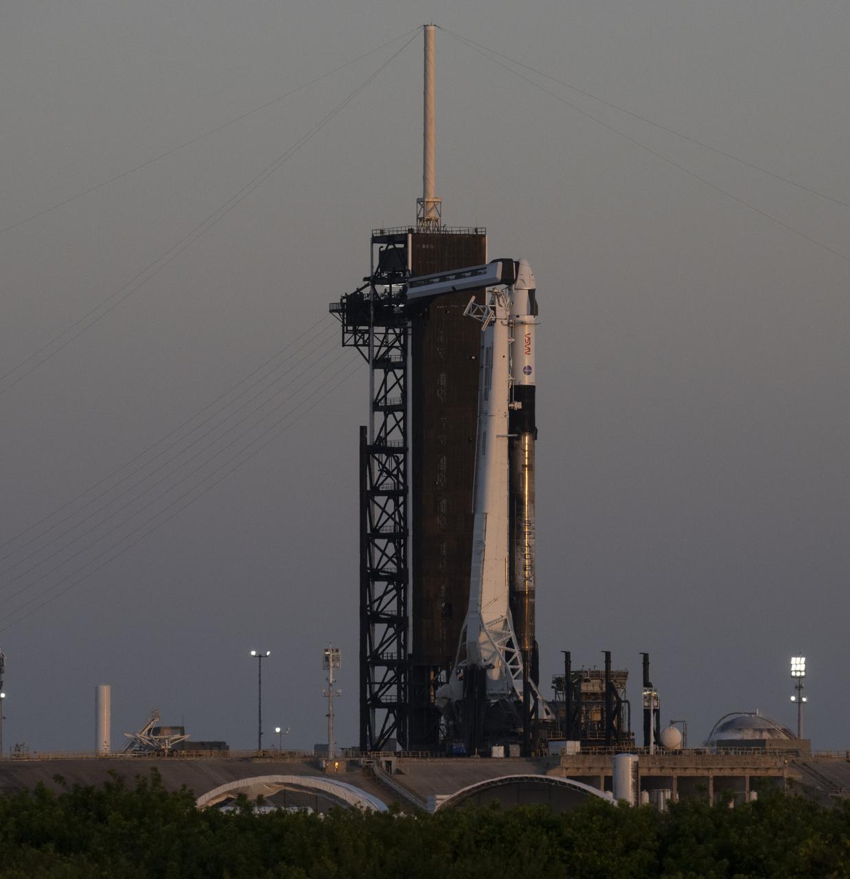 A SpaceX Falcon 9 rocket with the company's Crew Dragon spacecraft onboard is seen at sunrise on the launch pad at Launch Complex 39A as preparations continue for the Crew-4 mission, Tuesday, April 26, 2022, at NASA’s Kennedy Space Center in Florida. NASA’s SpaceX Crew-4 mission is the fourth crew rotation mission of the SpaceX Crew Dragon spacecraft and Falcon 9 rocket to the International Space Station as part of the agency’s Commercial Crew Program. NASA astronauts Kjell Lindgren, Robert Hines, Jessica Watkins, and ESA (European Space Agency) astronaut Samantha Cristoforetti are scheduled to launch on no earlier than April 27, from Launch Complex 39A at the Kennedy Space Center. Photo Credit: (NASA/Joel Kowsky)