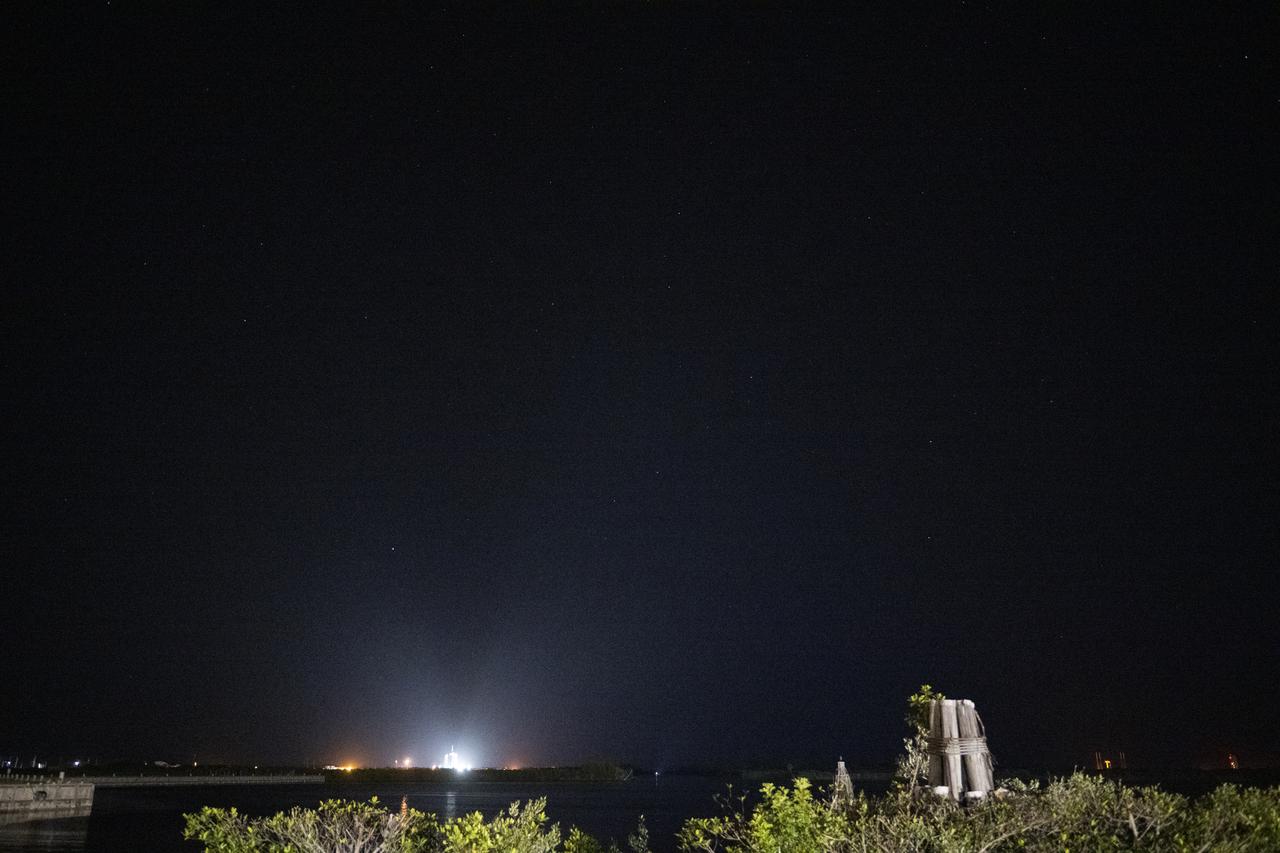 A SpaceX Falcon 9 rocket with the company's Crew Dragon spacecraft onboard is seen illuminated by spotlights on the launch pad at Launch Complex 39A as preparations continue for the Crew-4 mission, Tuesday, April 26, 2022, at NASA’s Kennedy Space Center in Florida. NASA’s SpaceX Crew-4 mission is the fourth crew rotation mission of the SpaceX Crew Dragon spacecraft and Falcon 9 rocket to the International Space Station as part of the agency’s Commercial Crew Program. NASA astronauts Kjell Lindgren, Robert Hines, Jessica Watkins, and ESA (European Space Agency) astronaut Samantha Cristoforetti are scheduled to launch on 3:52 a.m. ET on April 27 from Launch Complex 39A at the Kennedy Space Center. Photo Credit: (NASA/Joel Kowsky)