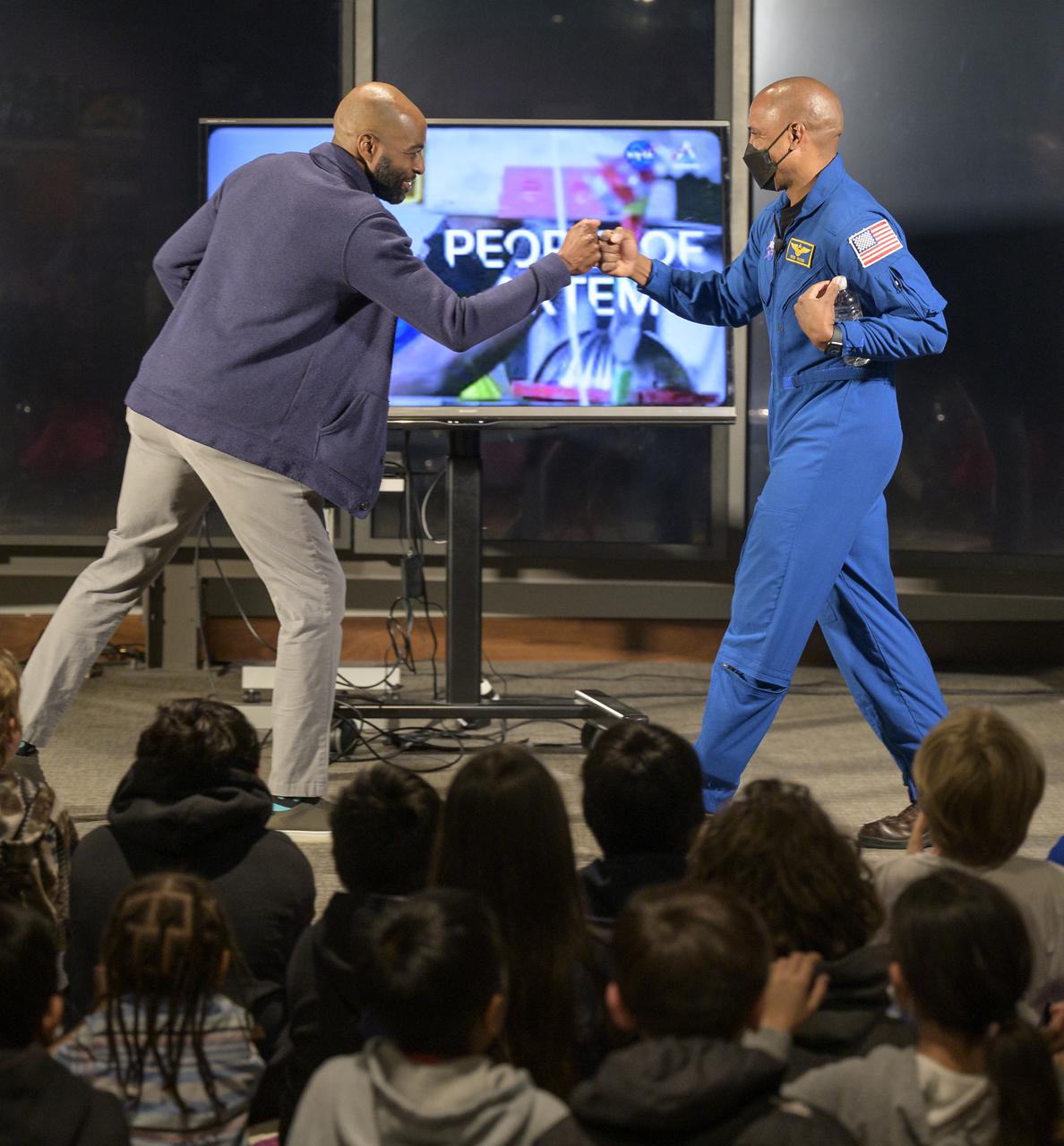 Christopher Williams, STEM Education Specialist for the National Museum of African American History and Culture, left, introduces NASA astronaut Victor Glover during an education event, Thursday, April 28, 2022, at the National Museum of African American History and Culture in Washington. Glover most recently served as pilot and second-in-command on the Crew-1 SpaceX Crew Dragon, named Resilience, which landed after a long duration mission aboard the International Space Station, May 2, 2021. Photo Credit: (NASA/Bill Ingalls)