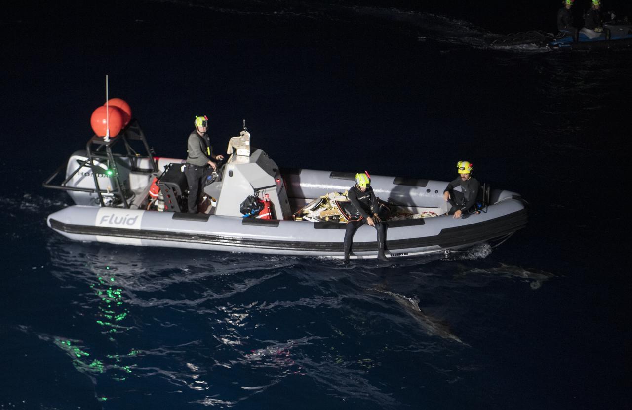 Dolphins swim alongside the SpaceX support teams after the SpaceX Crew Dragon Endurance spacecraft landed with NASA astronauts Raja Chari, Kayla Barron, Tom Marshburn, and ESA (European Space Agency) astronaut Matthias Maurer aboard, in the Gulf of Mexico, off the coast of Tampa, Florida, Friday, May 6, 2022. Maurer, Marshburn, Chari, and Barron are returning after 177 days in space as part of Expeditions 66 and 67 aboard the International Space Station. Photo Credit: (NASA/Aubrey Gemignani)