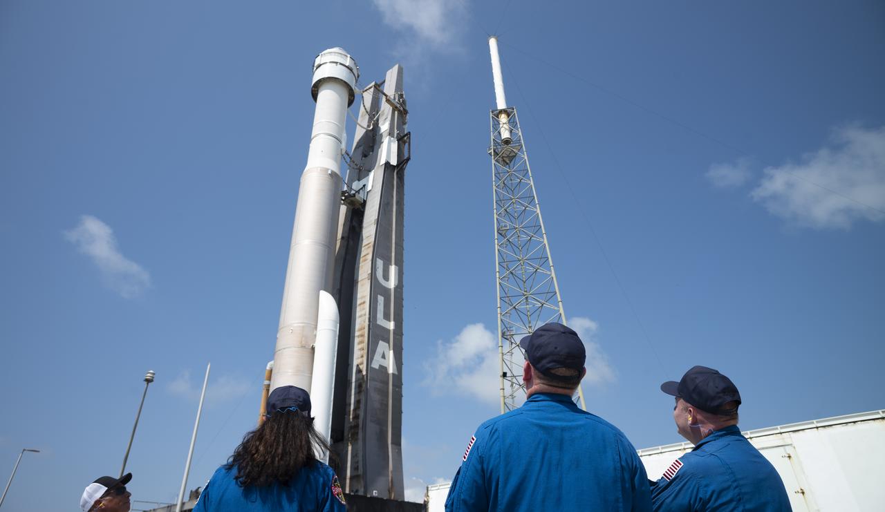 NASA astronauts Suni Williams, left, Barry "Butch" Wilmore, center, and Mike Fincke, right, watch as a United Launch Alliance Atlas V rocket with Boeing’s CST-100 Starliner spacecraft aboard is rolled out of the Vertical Integration Facility to the launch pad at Space Launch Complex 41 ahead of the Orbital Flight Test-2 (OFT-2) mission, Wednesday, May 18, 2022 at Cape Canaveral Space Force Station in Florida. Boeing’s Orbital Flight Test-2 will be Starliner’s second uncrewed flight test and will dock to the International Space Station as part of NASA's Commercial Crew Program. The mission, currently targeted for launch at 6:54 p.m. ET on May 19, will serve as an end-to-end test of the system's capabilities. Photo Credit: (NASA/Joel Kowsky)