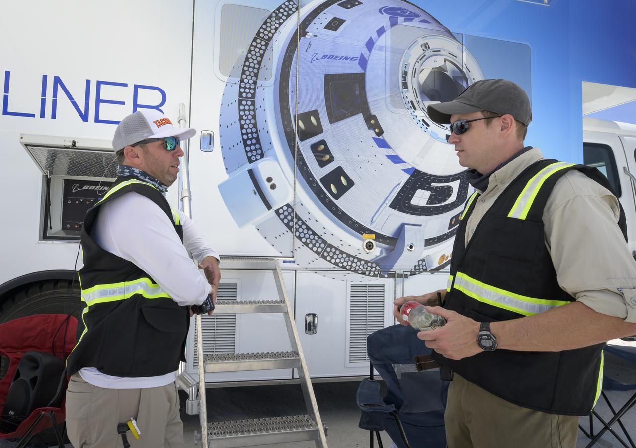 Boeing Recovery Director Bryan Gartner, left, and Boeing Starliner Launch Conductor Louis Atchison prepare for the landing of Boeing’s CST-100 Starliner spacecraft at White Sands Missile Range’s Space Harbor, Wednesday, May 25, 2022, in New Mexico. Boeing’s Orbital Flight Test-2 (OFT-2) is Starliner’s second uncrewed flight test to the International Space Station as part of NASA's Commercial Crew Program. OFT-2 serves as an end-to-end test of the system's capabilities. Photo Credit: (NASA/Bill Ingalls)