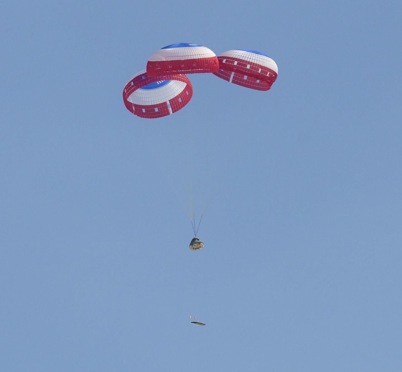 The Boeing CST-100 Starliner spacecraft jettisons the heat shield as it lands at White Sands Missile Range’s Space Harbor, Wednesday, May 25, 2022, in New Mexico. Boeing’s Orbital Flight Test-2 (OFT-2) is Starliner’s second uncrewed flight test to the International Space Station as part of NASA's Commercial Crew Program. OFT-2 serves as an end-to-end test of the system's capabilities. Photo Credit: (NASA/Bill Ingalls)