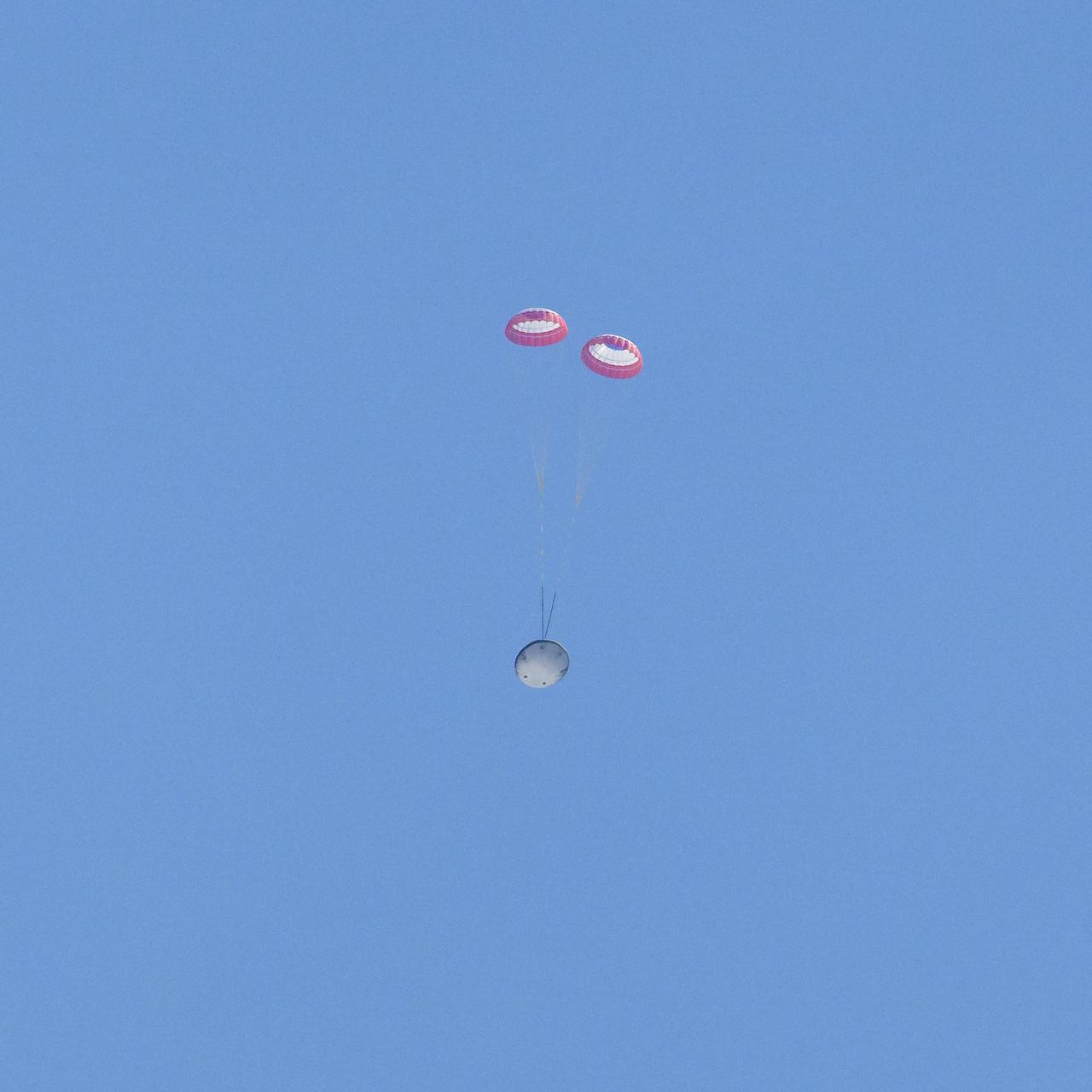 Boeing’s CST-100 Starliner spacecraft is seen under drogue parachutes as it lands at White Sands Missile Range’s Space Harbor, Wednesday, May 25, 2022, in New Mexico. Boeing’s Orbital Flight Test-2 (OFT-2) is Starliner’s second uncrewed flight test to the International Space Station as part of NASA's Commercial Crew Program. OFT-2 serves as an end-to-end test of the system's capabilities. Photo Credit: (NASA/Bill Ingalls)