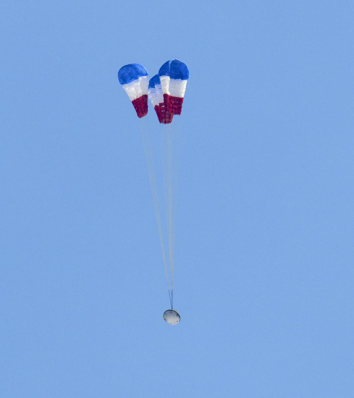 Boeing’s CST-100 Starliner spacecraft opens it’s main parachutes as it lands at White Sands Missile Range’s Space Harbor, Wednesday, May 25, 2022, in New Mexico. Boeing’s Orbital Flight Test-2 (OFT-2) is Starliner’s second uncrewed flight test to the International Space Station as part of NASA's Commercial Crew Program. OFT-2 serves as an end-to-end test of the system's capabilities. Photo Credit: (NASA/Bill Ingalls)