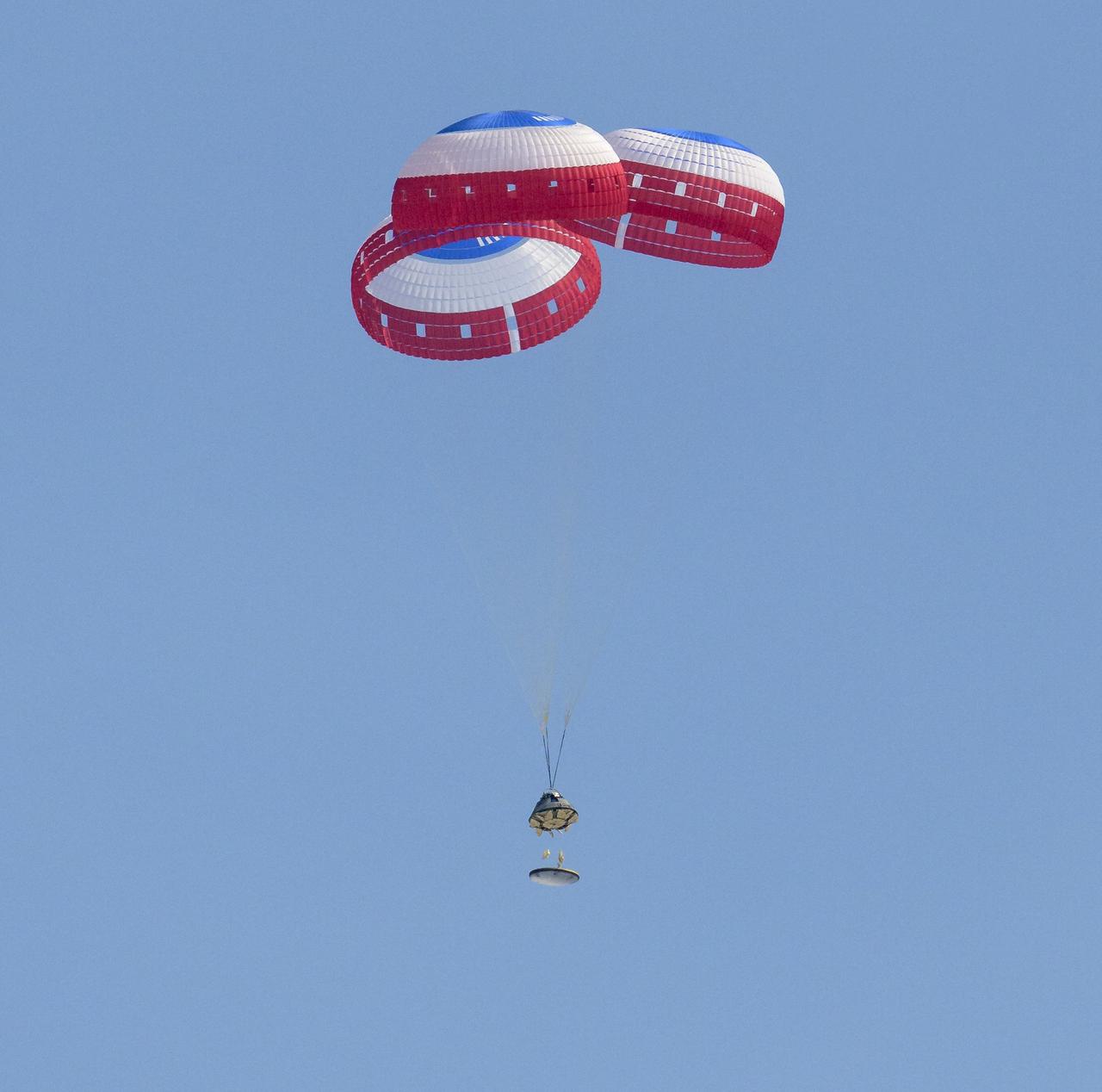 The Boeing CST-100 Starliner spacecraft jettisons the heat shield as it lands at White Sands Missile Range’s Space Harbor, Wednesday, May 25, 2022, in New Mexico. Boeing’s Orbital Flight Test-2 (OFT-2) is Starliner’s second uncrewed flight test to the International Space Station as part of NASA's Commercial Crew Program. OFT-2 serves as an end-to-end test of the system's capabilities. Photo Credit: (NASA/Bill Ingalls)