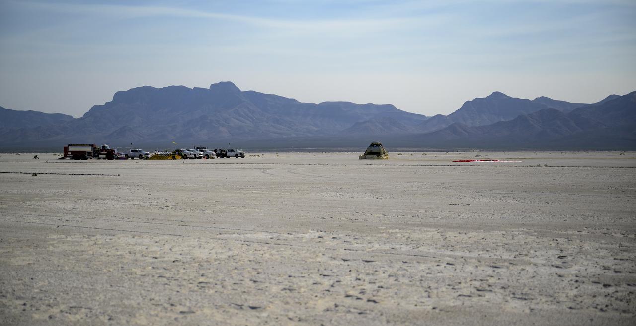 Boeing and NASA teams arrive at Boeing’s CST-100 Starliner spacecraft after it landed at White Sands Missile Range’s Space Harbor, Wednesday, May 25, 2022, in New Mexico. Boeing’s Orbital Flight Test-2 (OFT-2) is Starliner’s second uncrewed flight test to the International Space Station as part of NASA's Commercial Crew Program. OFT-2 serves as an end-to-end test of the system's capabilities. Photo Credit: (NASA/Bill Ingalls)