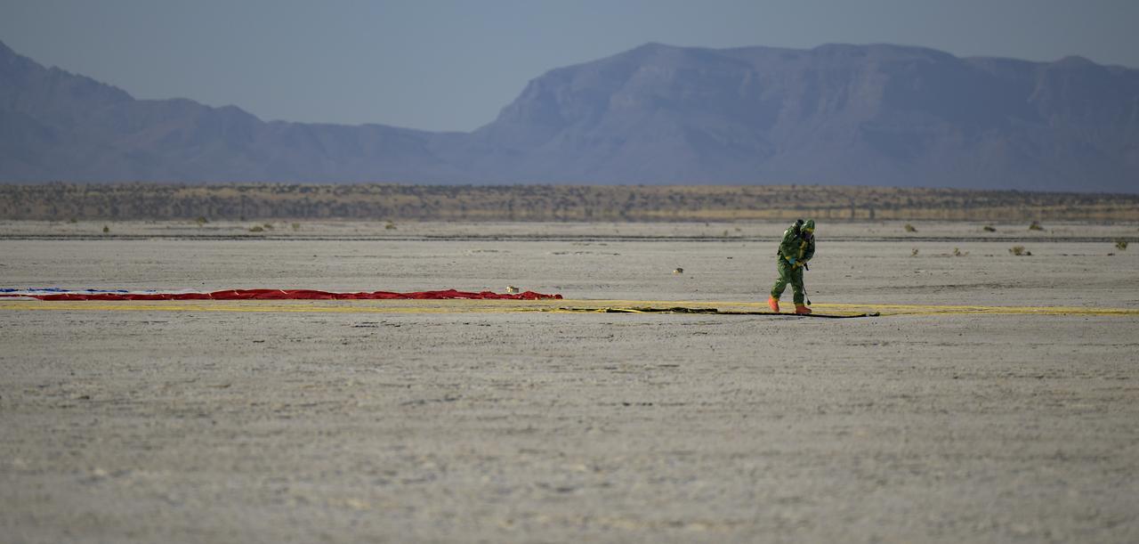 A Boeing team member checks the Boeing CST-100 Starliner parachute after the spacecraft landed at White Sands Missile Range’s Space Harbor, Wednesday, May 25, 2022, in New Mexico. Boeing’s Orbital Flight Test-2 (OFT-2) is Starliner’s second uncrewed flight test to the International Space Station as part of NASA's Commercial Crew Program. OFT-2 serves as an end-to-end test of the system's capabilities. Photo Credit: (NASA/Bill Ingalls)