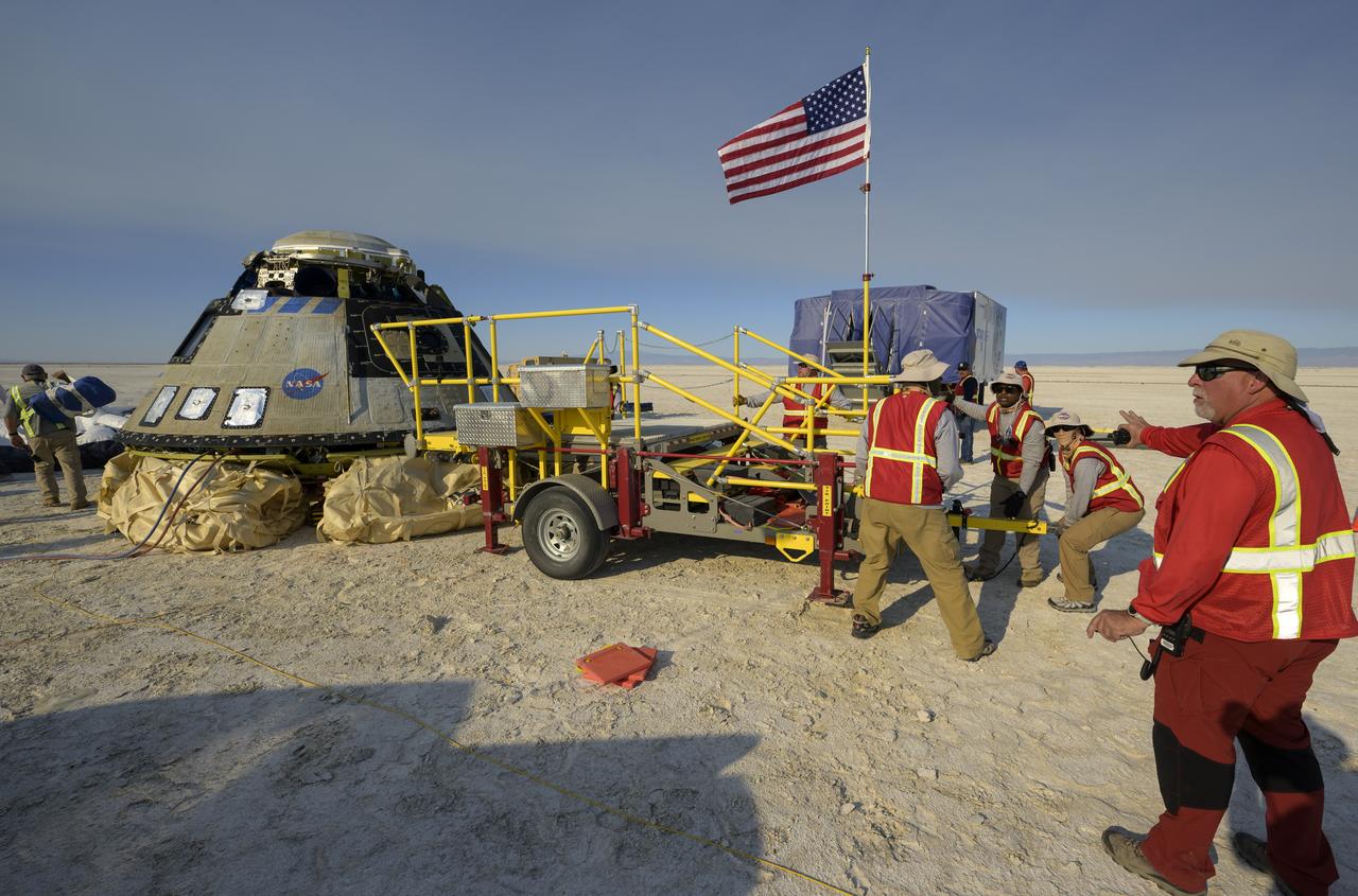 Boeing and NASA teams work around Boeing’s CST-100 Starliner spacecraft after it landed at White Sands Missile Range’s Space Harbor, Wednesday, May 25, 2022, in New Mexico. Boeing’s Orbital Flight Test-2 (OFT-2) is Starliner’s second uncrewed flight test to the International Space Station as part of NASA's Commercial Crew Program. OFT-2 serves as an end-to-end test of the system's capabilities. Photo Credit: (NASA/Bill Ingalls)